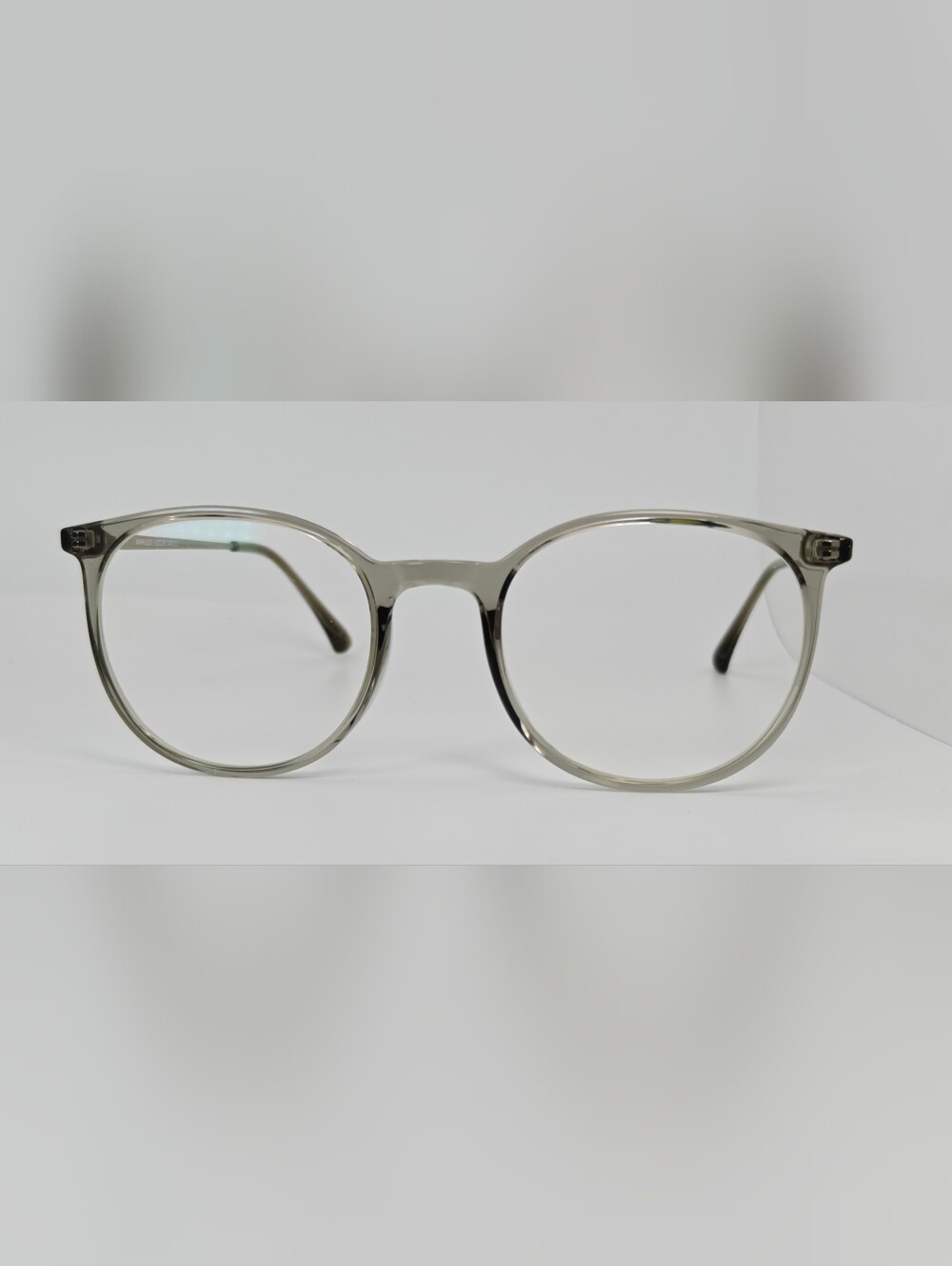 Marilou Classic Round Eyeglasses in Transparent Gray. Minimalist